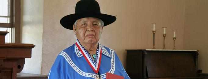Bertram Bobb posing in the church with his Choctaw Hymn Book. Photo by Bill Sheehy.