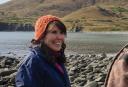 Alex Sugak (Alutiiq) talks with Isabella Blatchford (Supiaq/Alutiiq/Inupiaq) after they walked across to Refuge Rock, also known as Awu’ak, where Russian fur traders massacred Alutiiqs in the 1780s. Isabella felt that reaching the island was crucial to her personal discovery of her Alutiiq heritage. Photo by Torsten Kjellstrand & Dog Mountain, LLC.